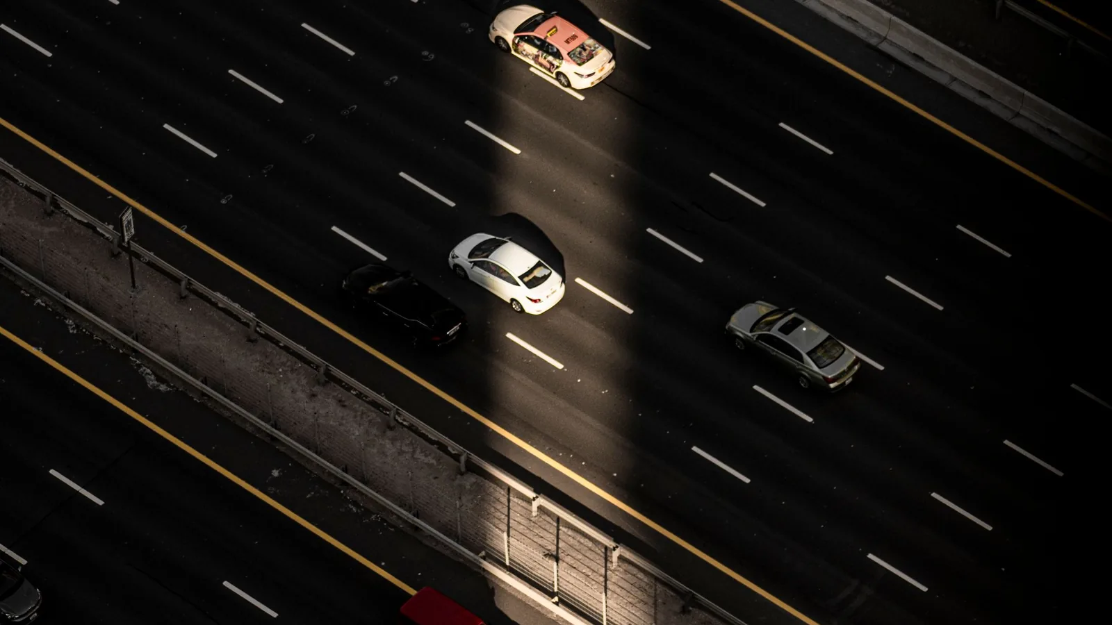 Aerial night view of multi-lane road traffic