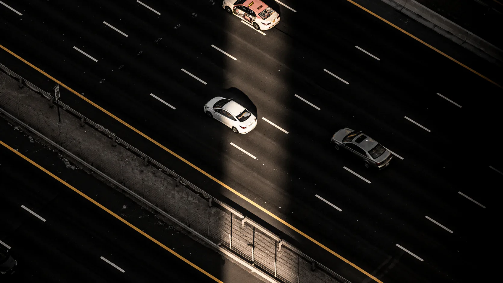 Cars travelling on a GCC motorway at night